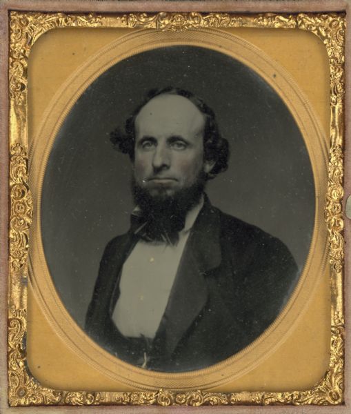 Sixth plate ferrotype/tintype of Daniel Wells, quarter length facing front, with hand-coloring on cheeks.
