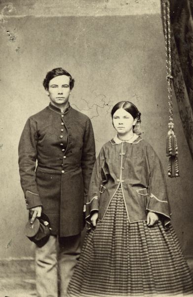 Studio portrait of Henry H. and Sarah Bennett. Henry is wearing the uniform of Company E, 12th Wisconsin Volunteers.
