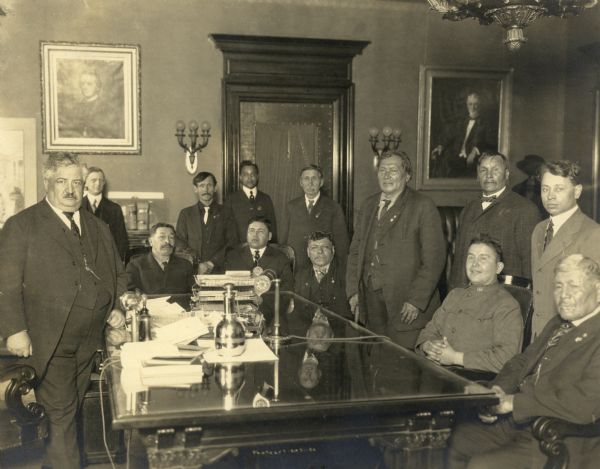 Wisconsin Governor Emmanuel Philipp in the Governor's Office during a conference with a delegation of Chippewa (Ojibwa) Indians. Executive Messenger Samuel Banks is standing at the door.