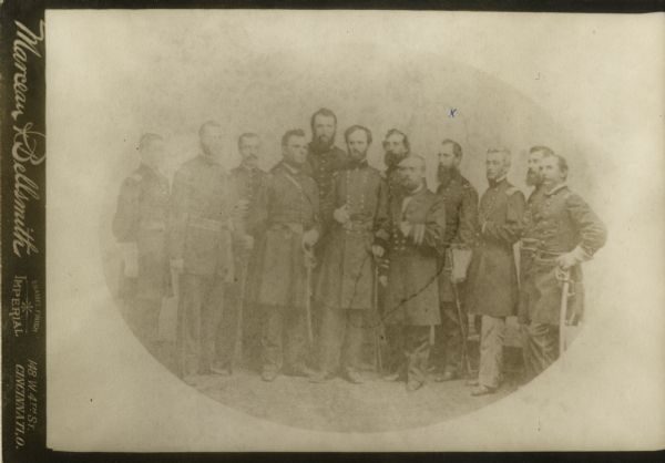 General William Tecumseh Sherman and his staff. The man fourth from the right marked with an "x" is believed to be General John H. Hammond. All are in uniform and most carry swords.
