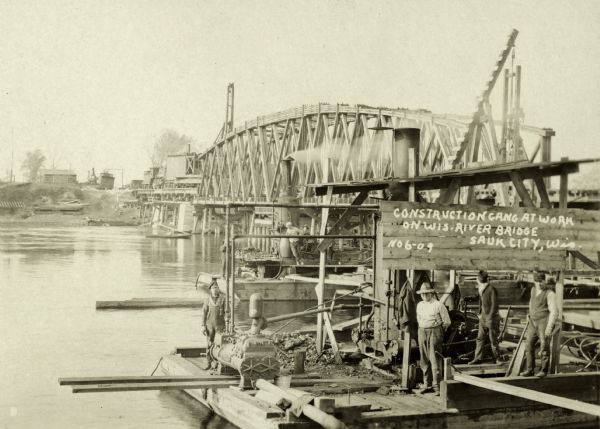 Construction gang at work on the Wisconsin River Bridge.