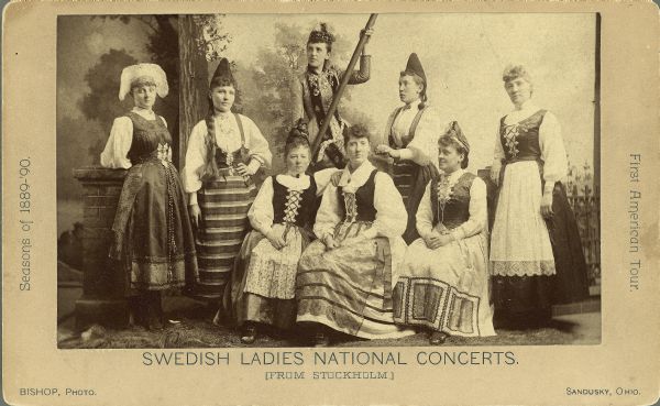 Studio portrait in front of a painted backdrop of a group of women from Stockholm on their first American Tour.