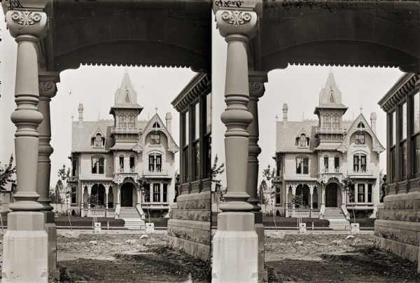 Exterior stereograph through an archway of a residence on Prospect Avenue.