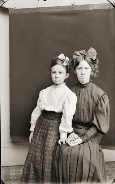 Studio portrait of Miriam and Ruth Bennett, daughters of Henry Hamilton (H.H.) and Evaline Bennett.