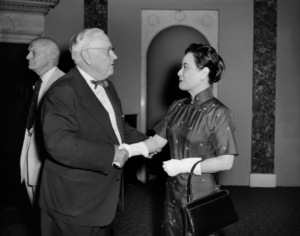 Senator Alexander Wiley shaking hands with Madame Chiang Kai-shek.