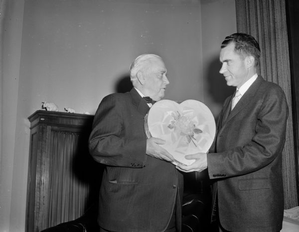 Senator Alexander Wiley presenting Vice President Richard M. Nixon with a heart-shaped box.