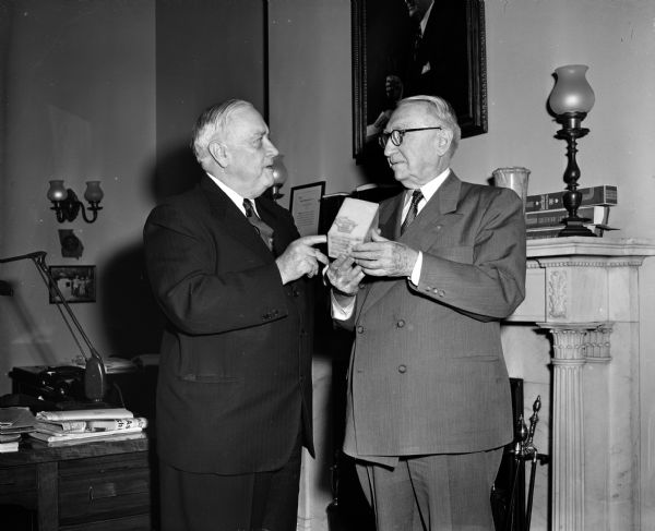 Senator Alexander Wiley presenting a block of cheese to Senator George.