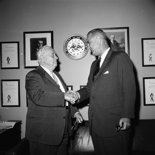 Senator Alexander Wiley shaking hands with Vice President Lyndon Johnson.