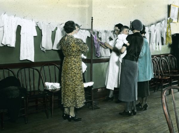 A nurse demonstrates several articles of clothing to mothers at the Health Center.