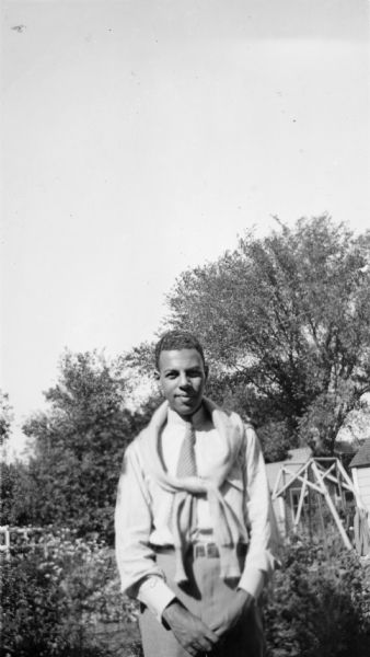 Ted Pierce poses outdoors with a sweater tied around his shoulders.