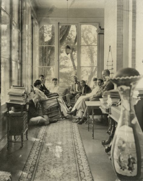 The Dousman family members sitting on a porch of Villa Louis.
