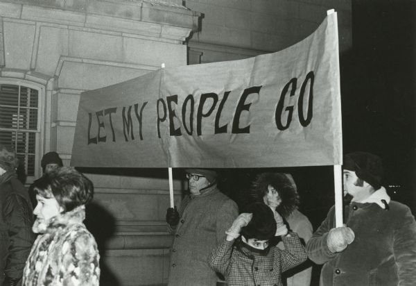 Several Jews march with a banner that reads "Let My People Go".