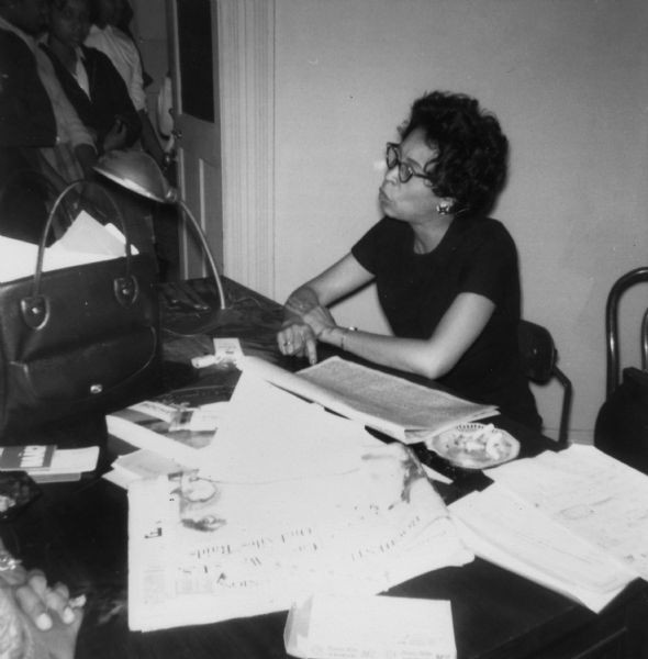 Daisy Bates seated at a desk in the NAACP office.