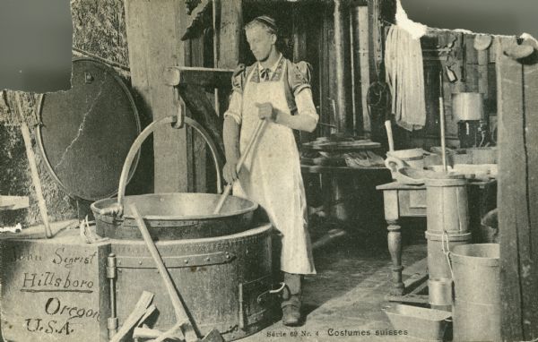 A man wearing Swiss clothing making cheese in Switzerland.