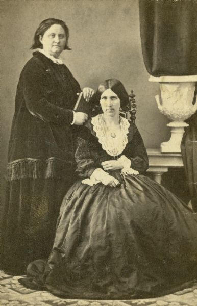 A studio portrait taken in Zurich of Mathilde Anneke, who is standing next to Mary Booth. Booth is seated.