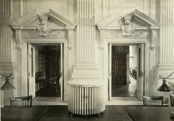 Detail view of the two doors at the north end of the Wisconsin Historical Society Library reading room which provided access to the separate periodical reading room. The large round object in the center is one of the three, marble-topped radiators located at each end of the room.