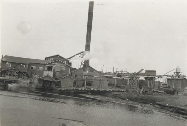 A view from water of the Thunder Lake Lumber Co., one of the largest sawmills in Rhinelander. It was located on Lake Creek and operated until 1937.