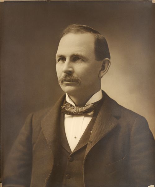 Quarter-length studio portrait of Walter Houser, former Wisconsin Secretary of State.