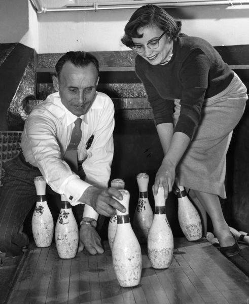 Father and daughter Theodore and Janet Weiss setting up bowling pins on Dads Day at Milwaukee-Downer College.