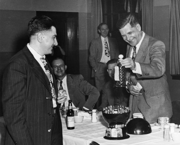 The presentation of the liquor trophy during the lithographer's intercity bowling dinner.