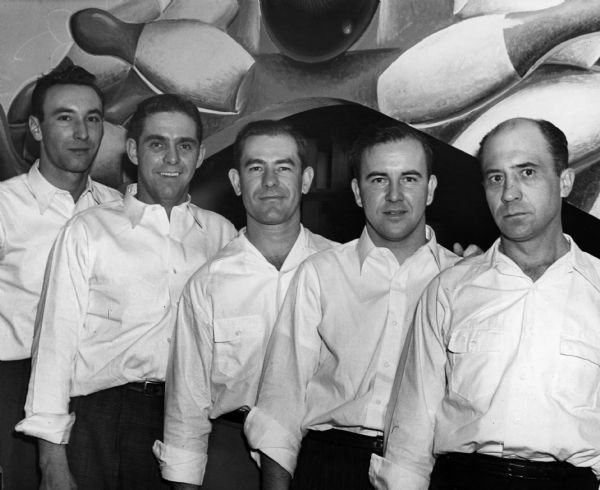 Team portrait of the Heil "Water Systems" bowling team who played at Antlers Hall. From left to right are Rolamel Schmidt, team captain Jack Burns, Leo Huscia, Leo Slowik, and Joe Strong.