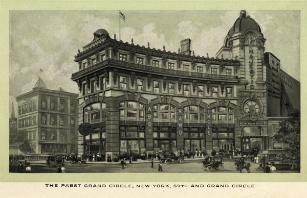 Exterior view of the Pabst Grand Circle Hotel and Majestic Theater. Streetcars, automobiles, carriages, horses and pedestrians line the streets. The marquis on the theater advertises the Wizard of Oz. A flag flies from the roof of the Grand Circle.