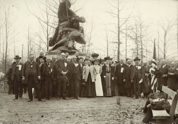 A group portrait taken in front of the Wisconsin Civil War Monument at its dedication ceremony. Third and fourth from the left in the front row are George W. Graves and George B. McMillan.