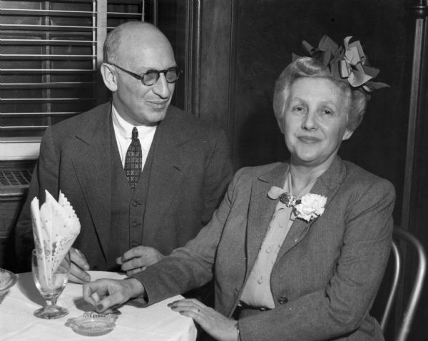 Lessing and Edith Rosenwald are seated together at a formal dinner.