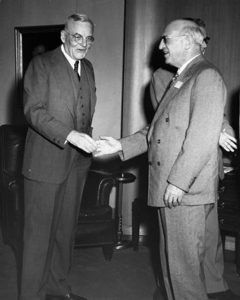 Lessing Rosenwald, of the American Council for Judaism, shakes hands with Secretary of State John Foster Dulles during a conference on United States foreign policy.