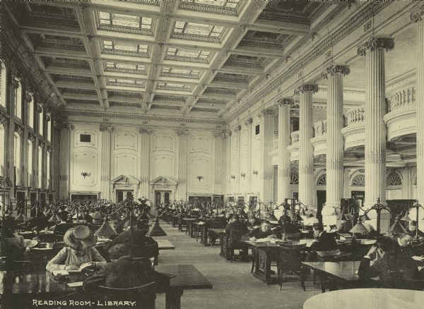View of the Wisconsin Historical Society Library Reading Room with people studying at tables.