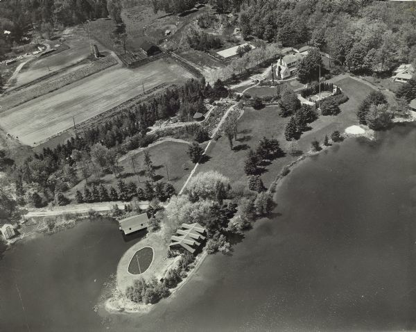 Aerial view of Kraftwood, the rural estate of the Kraft family of the Kraft Foods Co. of Wisconsin. The estate is situated on a peninsula jutting into Enterprise Lake (formerly known as Lake Mach-kin-o-siew.)