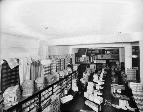 Elevated view of Montgomery Ward Co. at 102 North Hamilton Street, showing linen department.