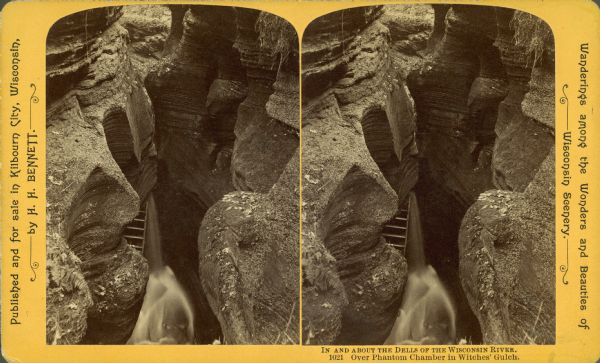 Stereograph over Phantom Chamber of a waterfall in Witches' Gulch. There is a ladder to the left of the waterfall.