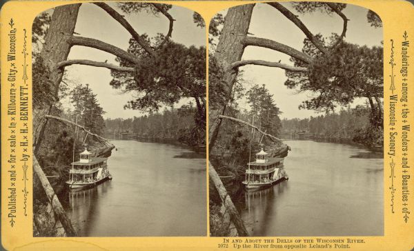 Stereograph of elevated view of a steamboat on the Wisconsin River. Text at right: "Wanderings Among the Wonders and Beauties of Wisconsin Scenery."