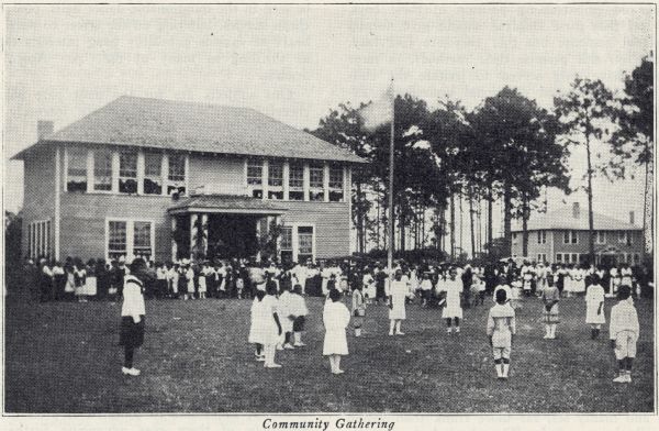 View of an outdoor gathering of an African American community.