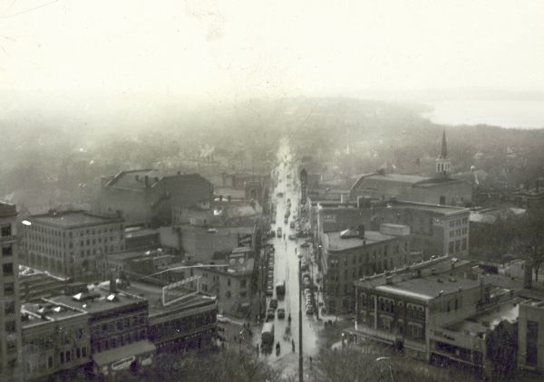 Elevated view down State Street. The Orpheum Theatre sign is visible, and in the distance is Lake Mendota.