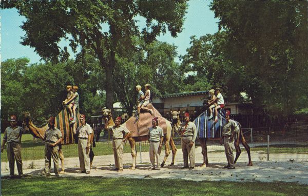 Camel rides at the Vilas Park Zoo (Henry Vilas Zoo) for children, given free by Zor Temple Camel Patrol on Sunday afternoons during the summer. A number of Shriners stand by to assist the camels.  Ralph Swiggum is third man from the left.