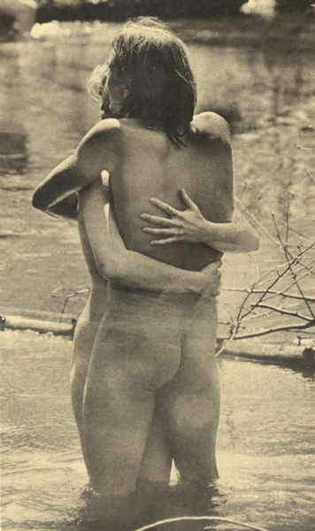 Steve Landall embraces his girlfirend while standing in a creek at the Sound Storm rock festival.