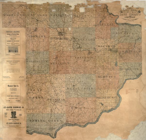 A wall atlas of Sauk County, Wisconsin, displaying its 22 towns. On the left side are advertisements for local businesses.