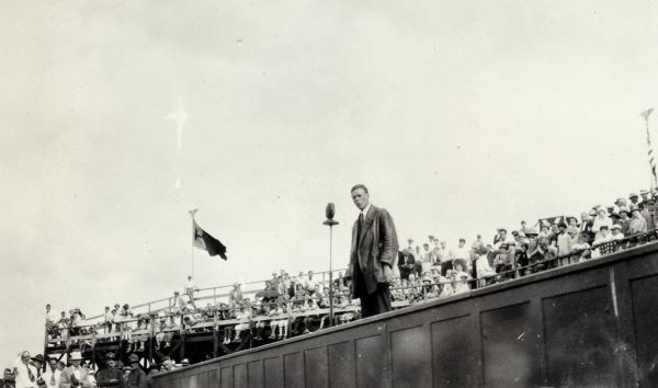 Charles Lindbergh speaking to a crowd at a stadium.