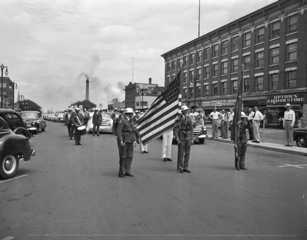 Madison Soap Box Derby Parade with the VFW Color Guard. Kroger Super Market and Uptown Liquor Store, located on the 100 block of East Washington Avenue, are in the background.