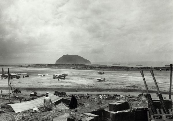 Airfield #1, Iwo Jima, with Mt Surabachi in the distance. This image is one of many taken by Milwaukee photographer Dickey Chapelle during the assault on Iwo Jima. She was present within nine days of the first Marine assault on February 19, 1945. The fighting there, which was among the bloodiest battles in U.S. Marine history, did not end until March.