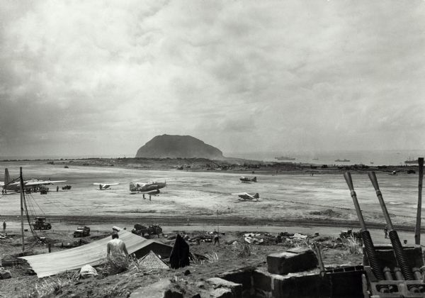 Airfield #1, Iwo Jima, with Mt Surabachi in the distance.  This image is one of many taken by Milwaukee photographer Dickey Chapelle during the assault on Iwo Jima.  She was present within nine days of the first Marine assault on February 19, 1945.  The fighting there, which was among the bloodiest battles in U.S. Marine history, did not end until March.