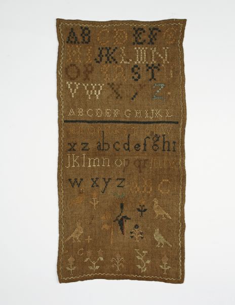 A sampler made in Ohio in 1850 with the alphabet in both upper and lower case stitched on it.
