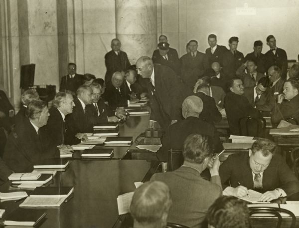 Snapshot of a break in the deliberations during the famous Roosevelt "Court Packing Case." Journalist Robert S. Allen, who was covering the story, can be seen in the lower right writing some notes.