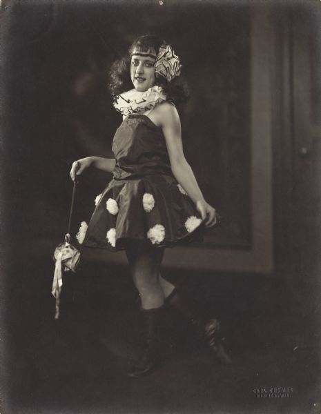 Full-length portrait of Pierre Sidell posing onstage in a dancing costume.