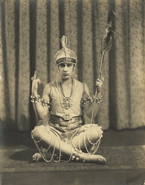 Billie Sidell poses seated, dressed in an elaborate, princely costume. She passes easily as a man.