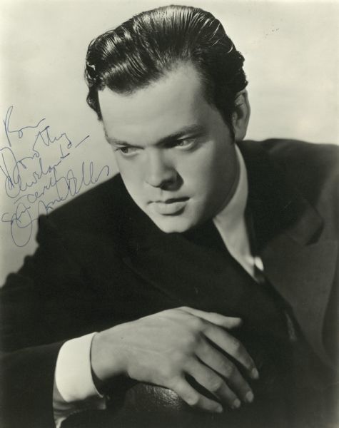 Portrait of a young, handsome Orson Welles with an inscription.