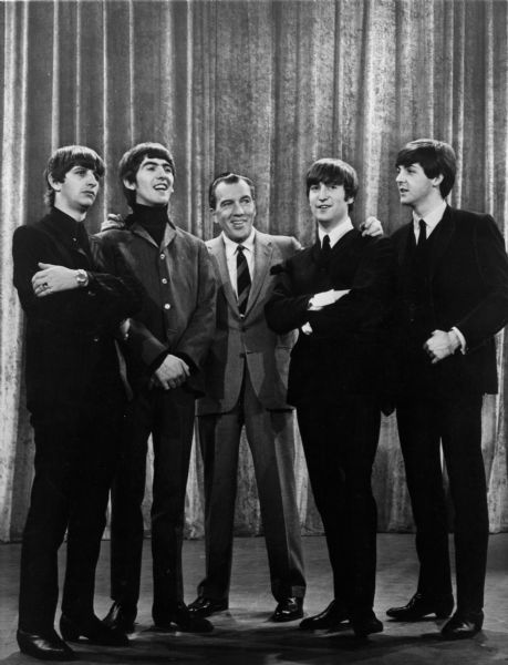 Ed Sullivan poses with the Beatles in February 1964.