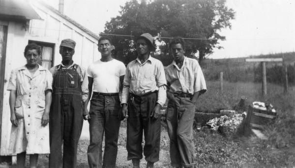 Members of the Arms family (and a friend?) pose on Bernard Arms's farm. From left to right are Nellie Arms, Bernard Arms, unidentified man with eyes rolled, Walter Arms and Orville Arms.